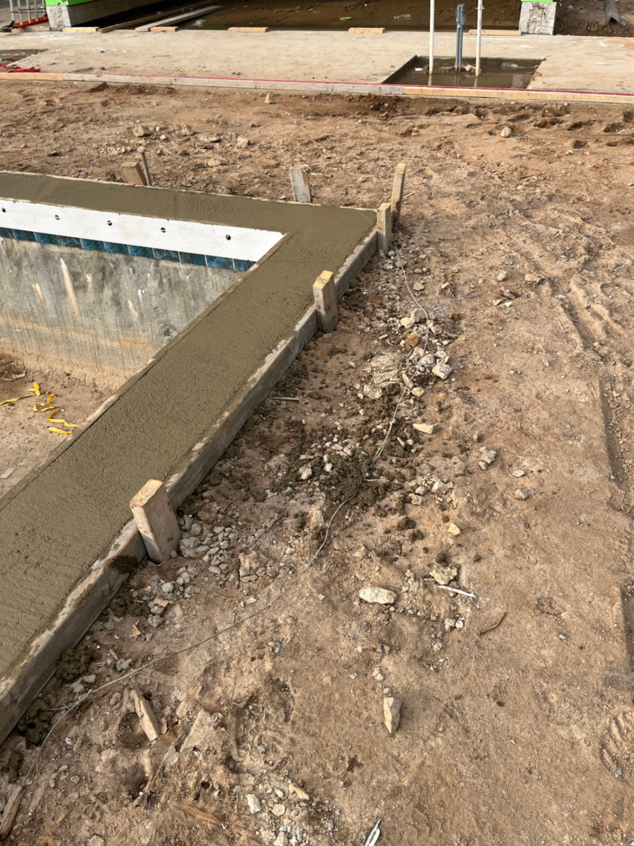Coping pour in progress — assisting with portions of the coping pour for both the pool and spa.