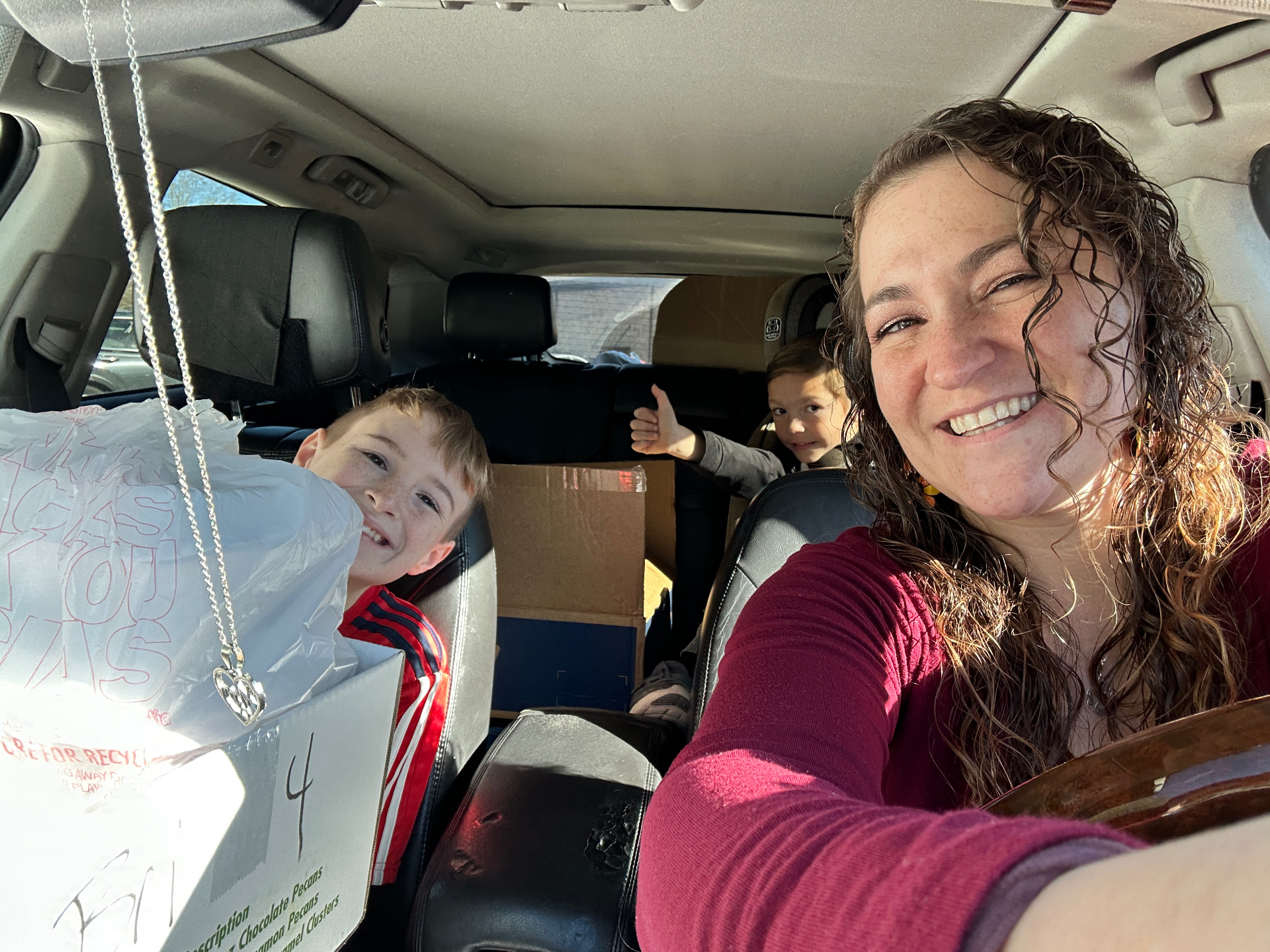 Thanksgiving meal delivery selfie in the car with meals packed for the community