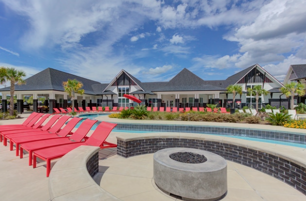 Pool deck, fire feature, and lounge seating overlooking the lazy river.