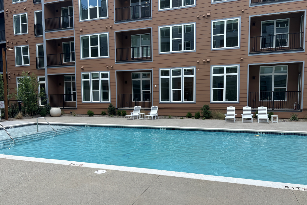 Wide view of the completed amenity pool with lounge seating.