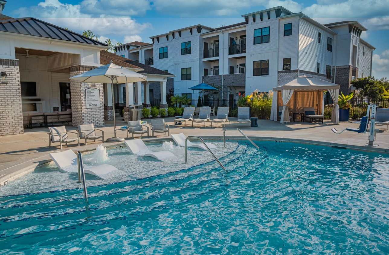 Pool deck with in-water loungers, shaded cabana, and resident lounge seating.